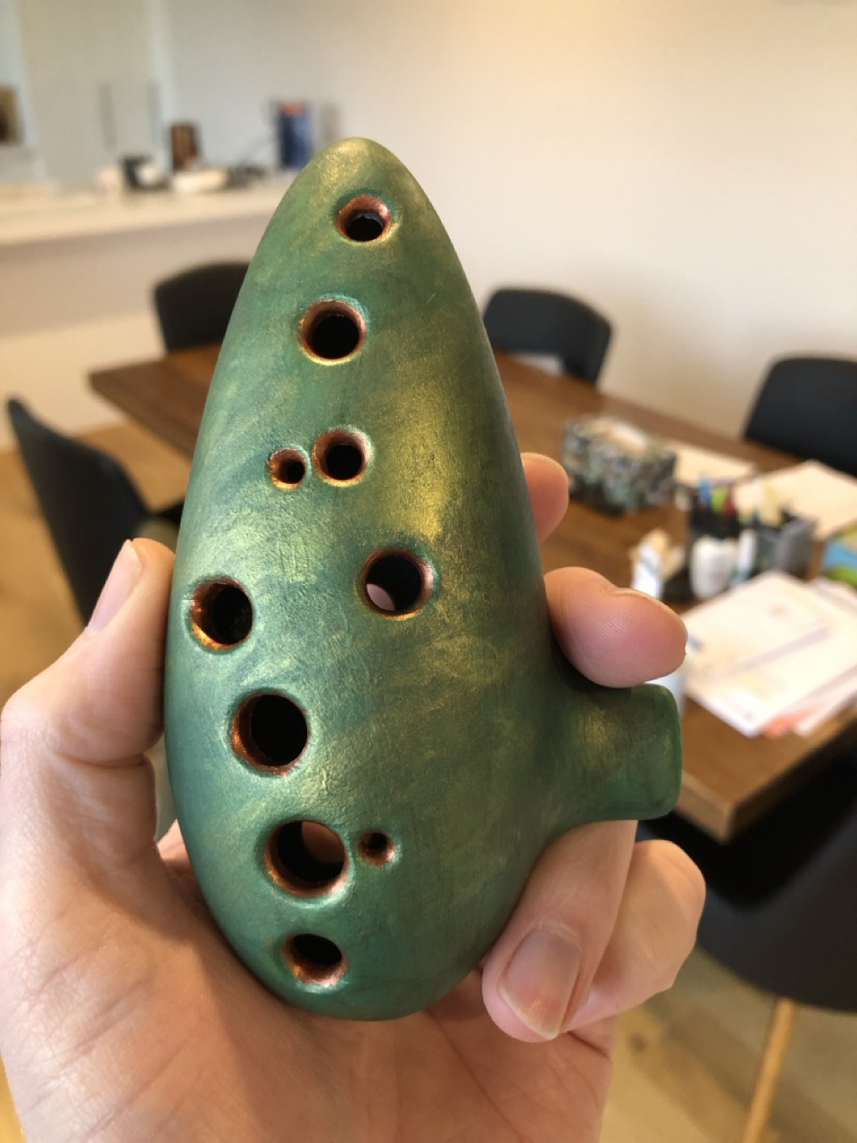 A 12-hole Ocarina in the key of C. 3D printed from a model on Printables, and painted by hand.